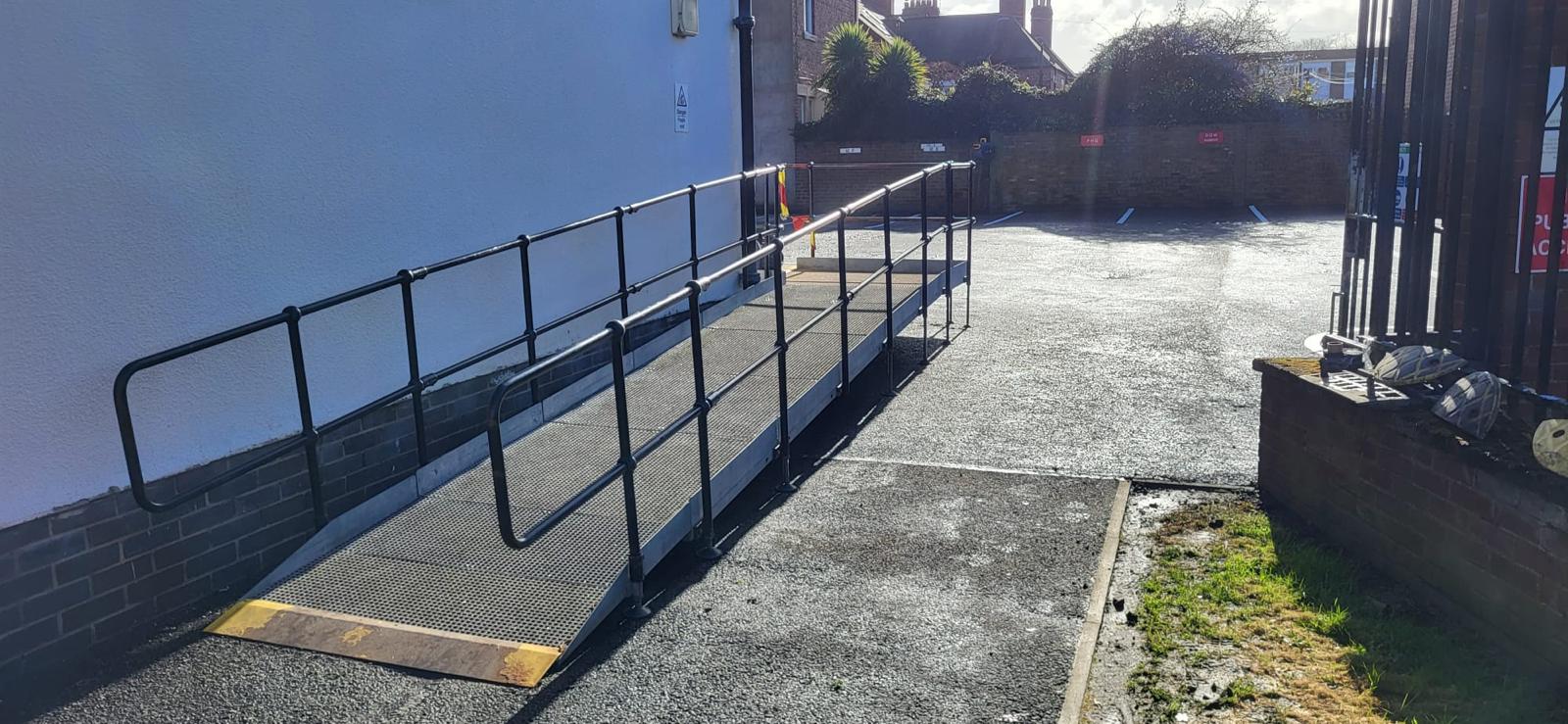 DDA wheelchair access ramp with tubular steel handrails