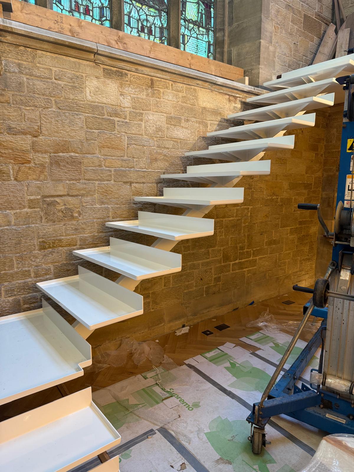 Full-height cantilever staircase with curved steel design
