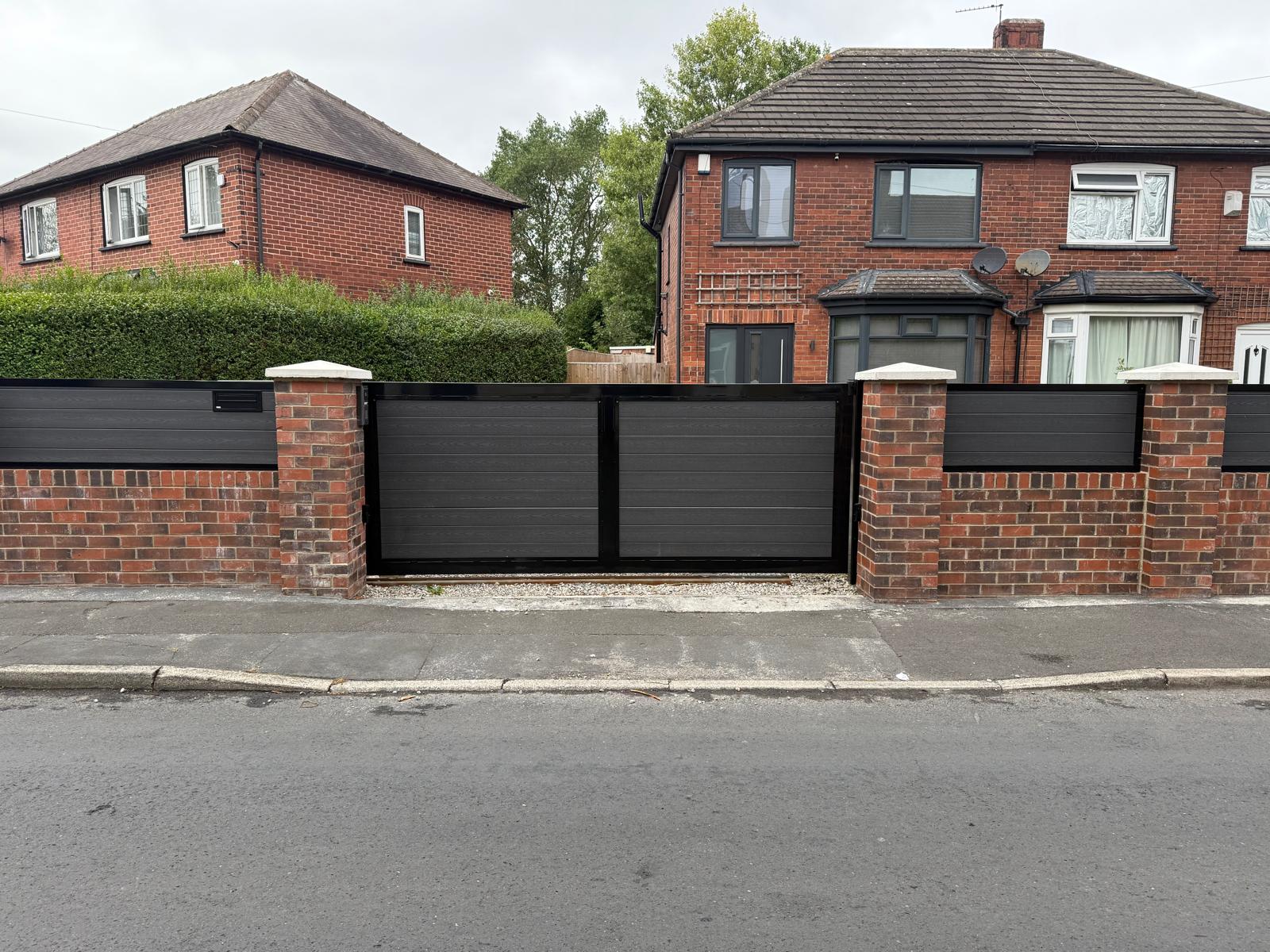 Dark grey bespoke metal gates on residential frontage