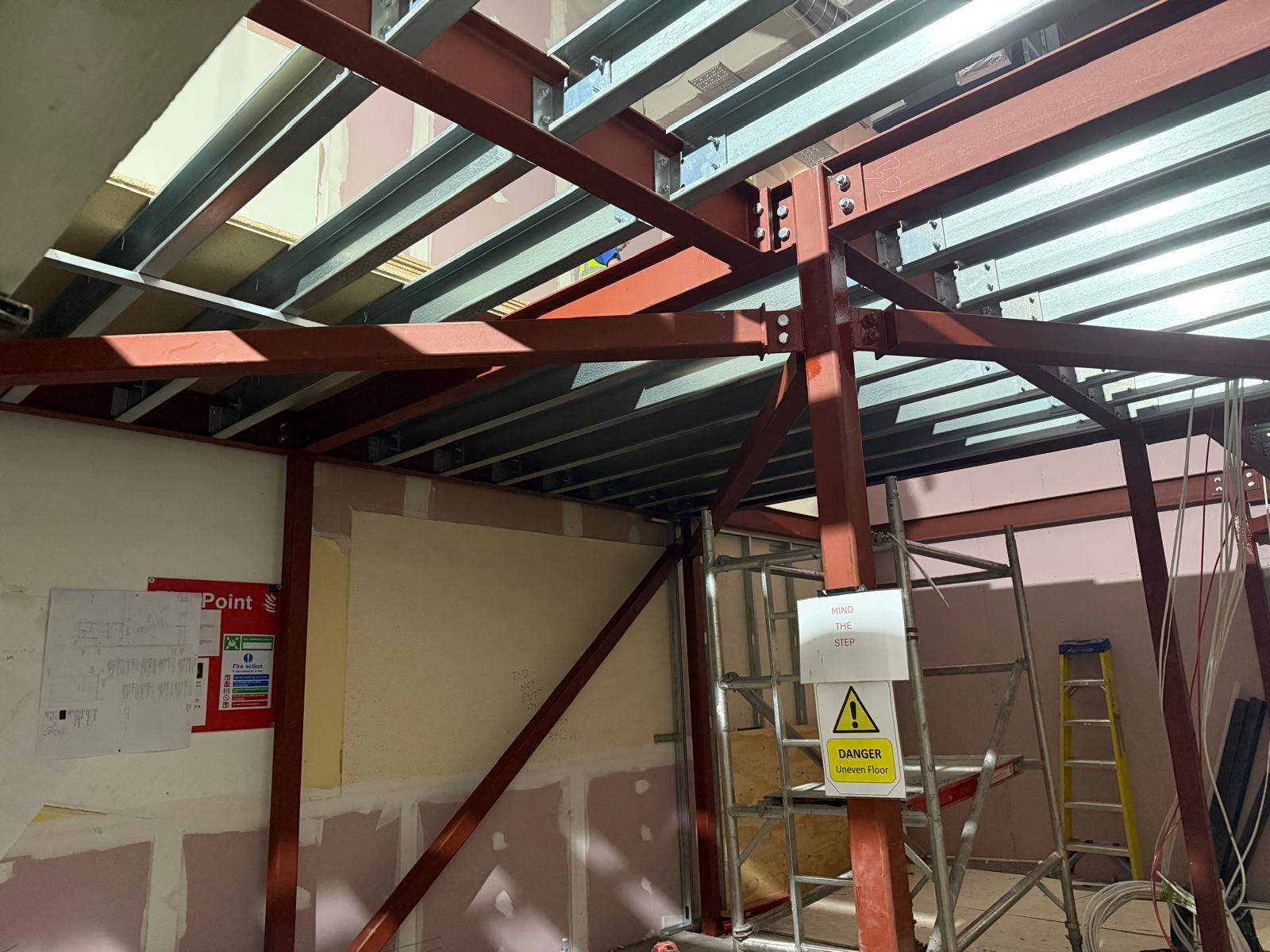 Structural steel beams viewed from below showing bolted connections
