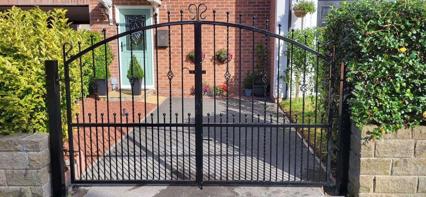Bespoke wrought iron driveway gates with decorative scrollwork by Colemans Steel
